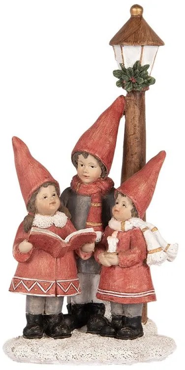 Villanyoszlop alatt éneklő gyerekek karácsonyi dekoráció