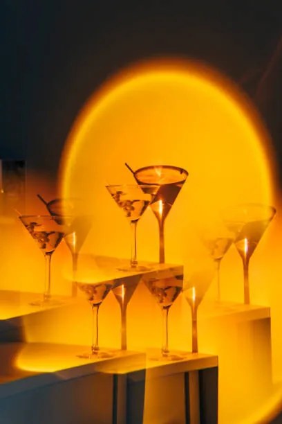 Fotográfia Kaleidoscope martini cocktail in orange neon, Nitas