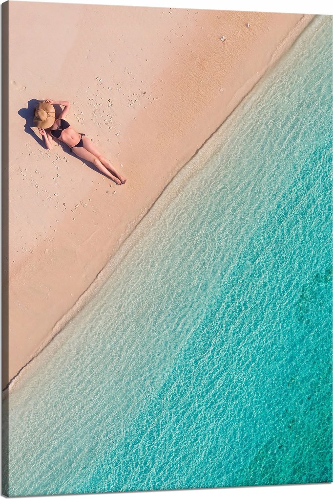 Vászonkép Nő napozik a tengerparton 80x120 cm
