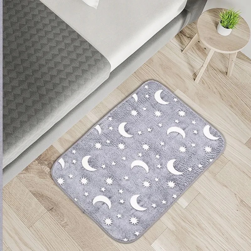 Foszforeszkáló szőnyeg Csillagok és holdak 60x40cm világít a sötétben