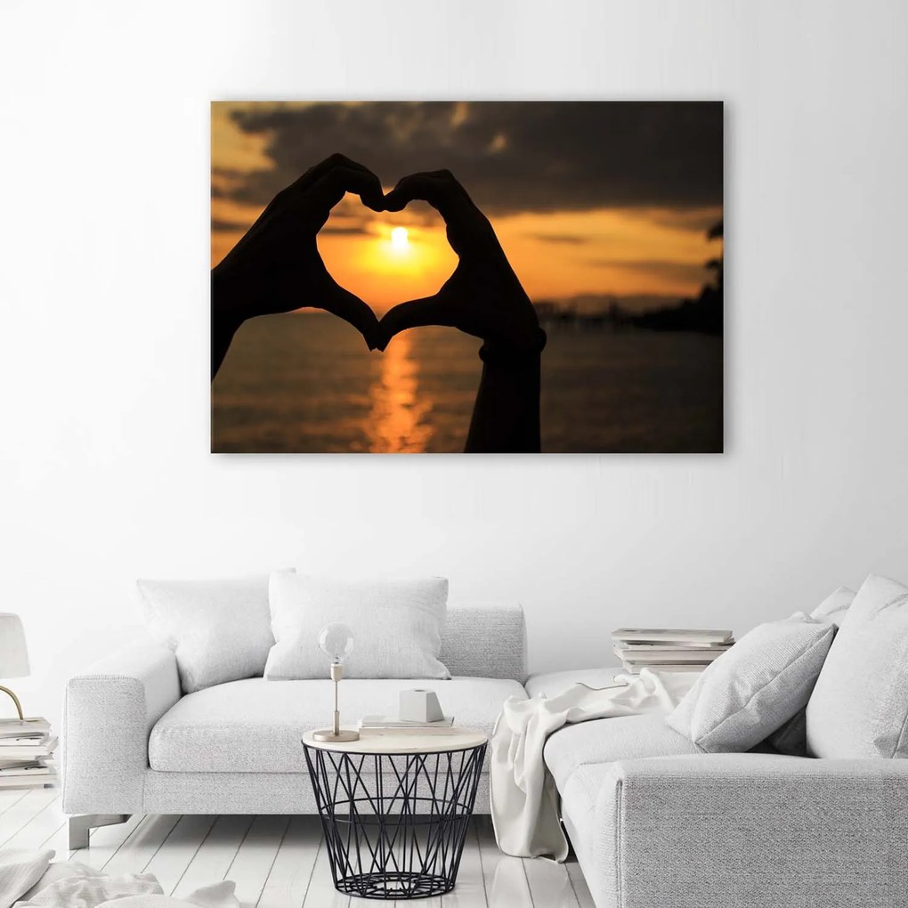 Gario Vászonkép Szív a kezekkel és a naplemente Méret: 100 x 70 cm