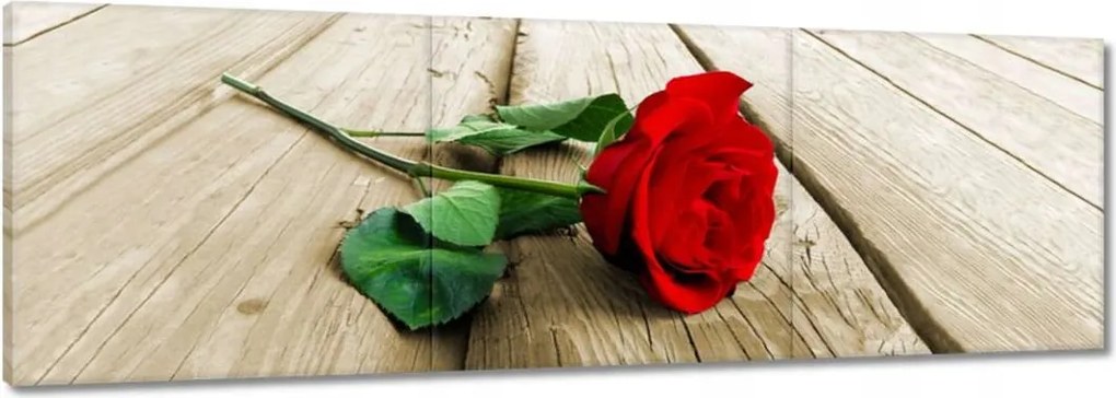 Vászonkép 60x20 Vörös rózsa a deszkákon