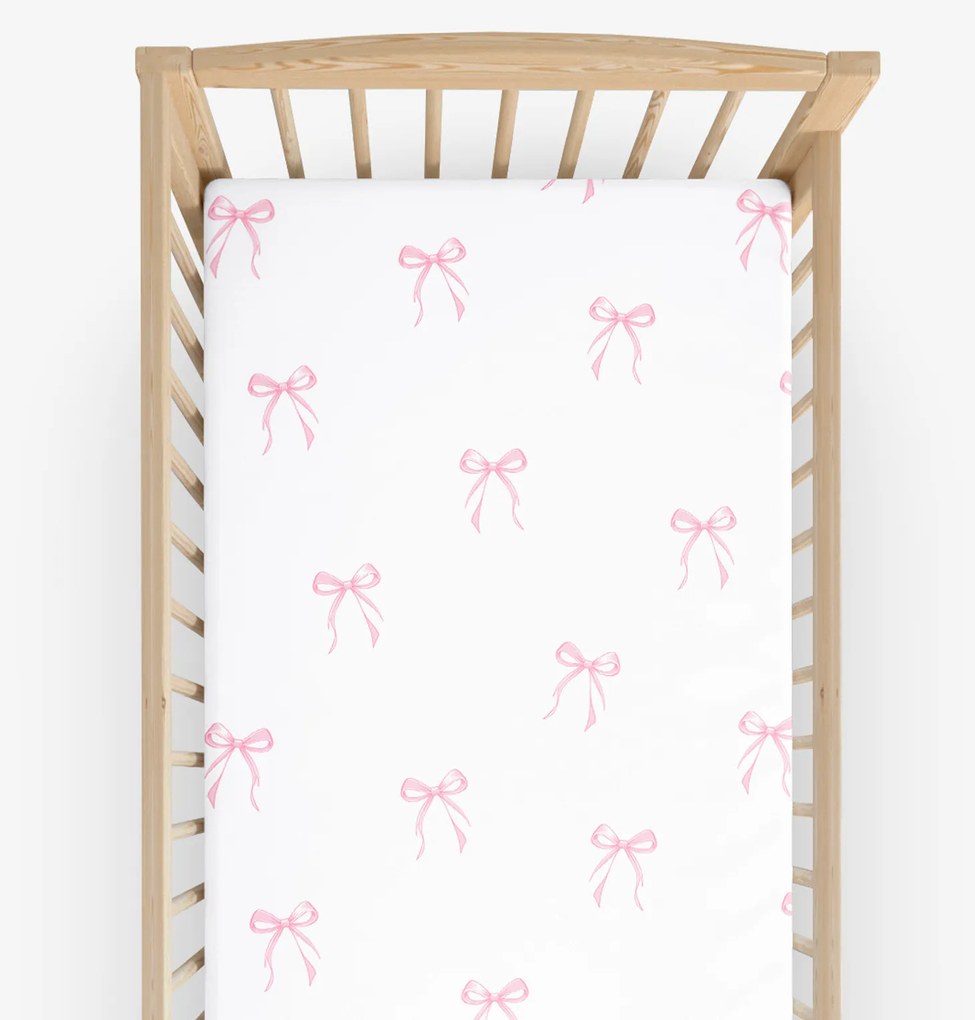 Goldea gyermek gumis pamut lepedő kiságyba - rózsaszín masnik 70 x 140 cm