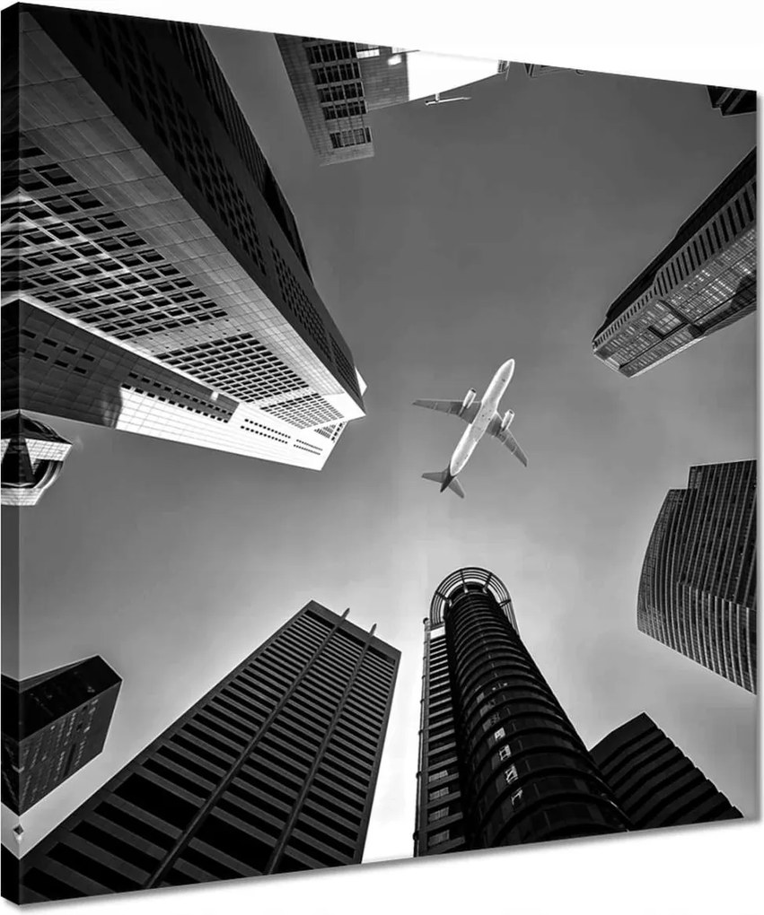 Vászonkép 40x40 Repülőgép a város felett