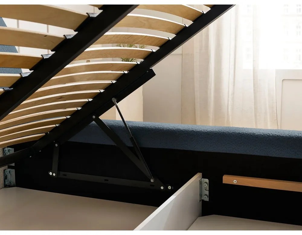 Sötétkék kárpitozott ágyneműtartós franciaágy ágyráccsal 140x190 cm Orlane – Bobochic Paris