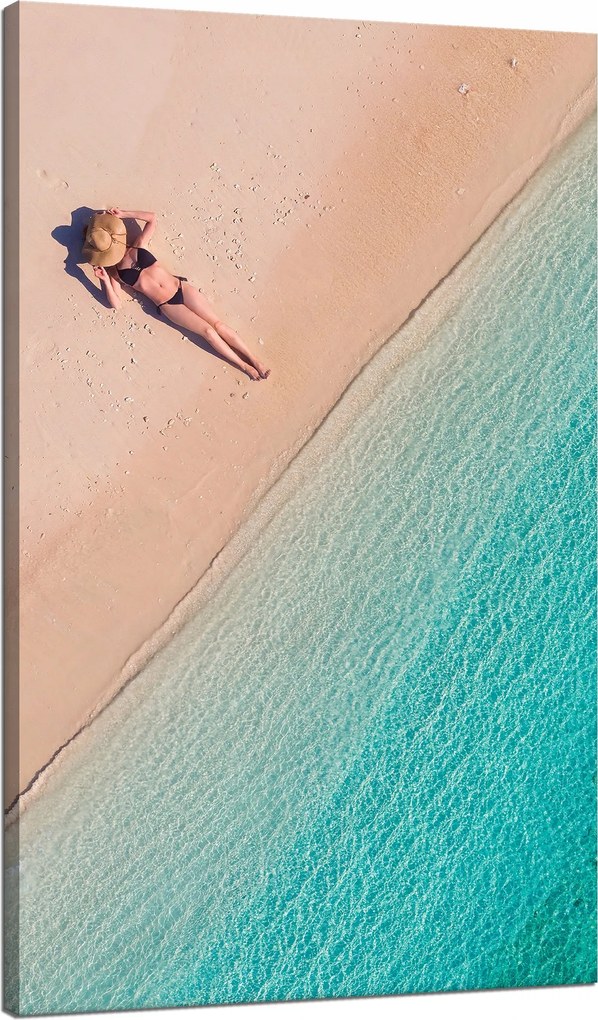 Vászonkép Nő napozik a tengerparton 70x120 cm