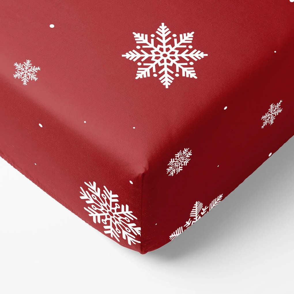 Goldea karácsonyi pamut körgumis lepedő - hópelyhek piros alapon 90 x 200 cm