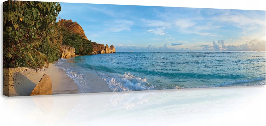 Vászonkép 145x45 Trópusi tengerpart óceán fehér homok kék víz hullámok sziklák