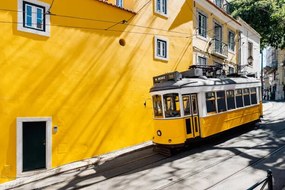 Fotográfia Yellow tram moving past yellow building, Alexander Spatari