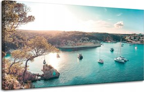 Vászonkép Víz a nap tükrében Csónakok Sziklák 120x60 cm