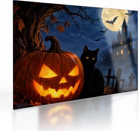Üveg kép - Fekete macska egy világító halloweeni tök mellett (70x50 cm)