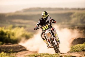 Fotográfia Man on dirt bike racing on dirt road in nature., skynesher