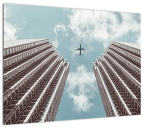 Repülőgép az épületek között képe (üvegen) (70x50 cm)