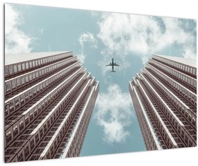 Repülőgép az épületek között képe (90x60 cm)