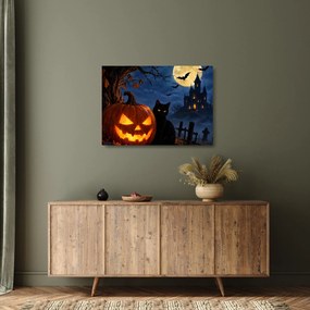 Üveg kép - Fekete macska egy világító halloweeni tök mellett (70x50 cm)