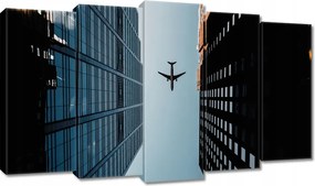 Vászonkép 100x60 Repülőgép épületek között