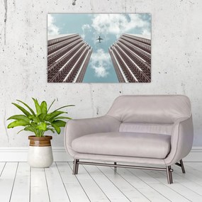 Repülőgép az épületek között képe (90x60 cm)