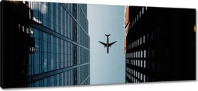 Vászonkép 100x40 Repülőgép az épületek között