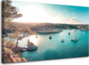 Vászonkép Víz a nap tükrében Csónakok Sziklák 100x60 cm