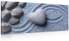 Kép szív alakú kő homokban