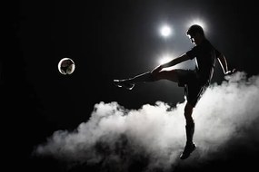 Fotográfia Soccer player kicking the ball at night on stadium, Stanislaw Pytel