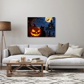 Üveg kép - Fekete macska egy világító halloweeni tök mellett (70x50 cm)
