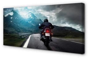 Canvas képek Motorkerékpár hegyi úton férfi ég 100x50 cm