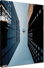 Vászonkép 30x40 Repülőgép az épületek között