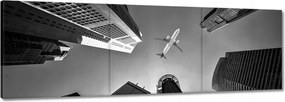 Vászonkép 60x20 Repülőgép a város felett