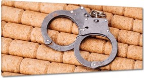 Vászonkép 115x55 Bilincsek parafa háttérrel