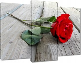 Vászonkép 90x70 Vörös rózsa a deszkákon