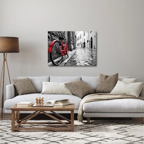 Egy vörös kerék képe egy macskaköves utcán (70x50 cm)